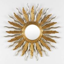 A large sunburst mirror, gilt and silvered sculptured wood. (D: 65 cm)