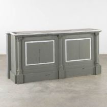 A patinated and sculptured wood counter. (L:56 x W:205 x H:96 cm)