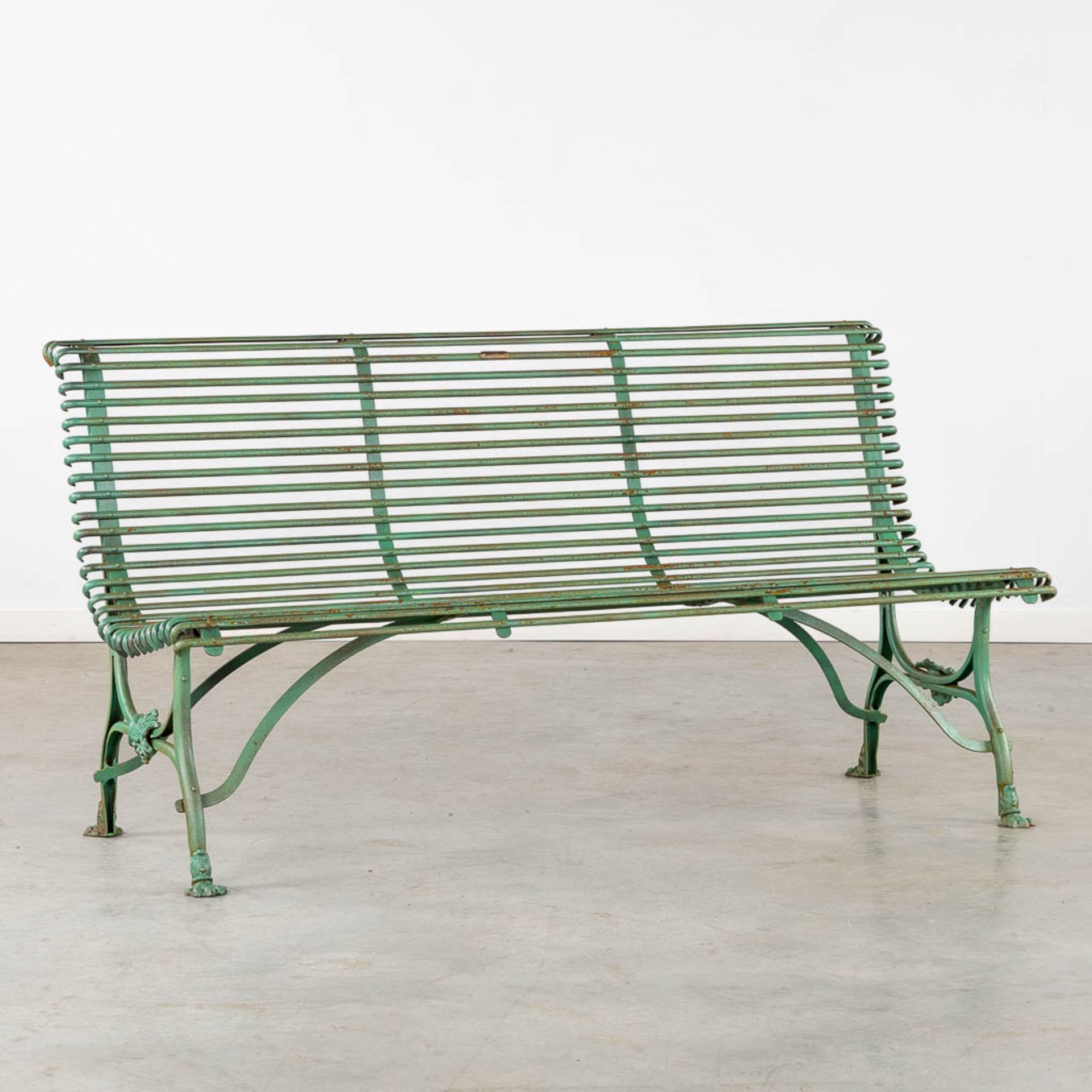 A green patinated garden bench, signed S. Sauveur, Arras. (L:66 x W:151 x H:80 cm)