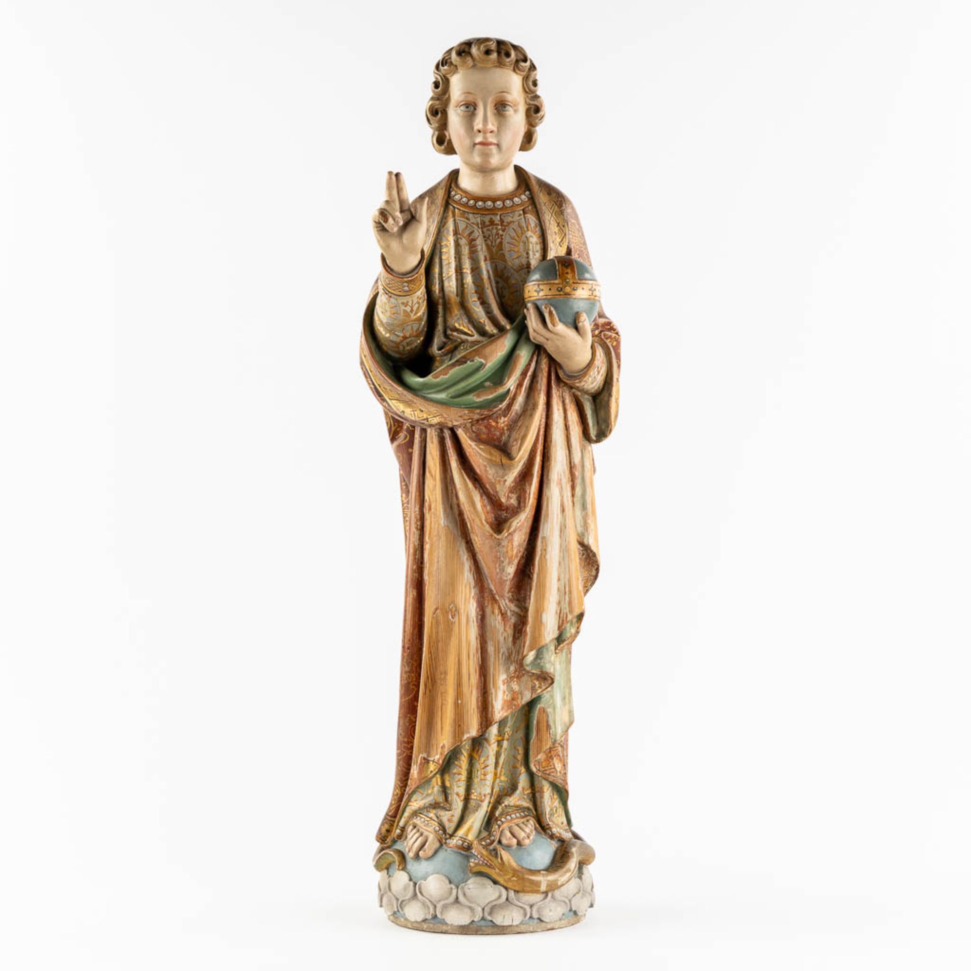 An antique wood-sculptured figurine of Salvator Mundi, holding a globus cruciger and serpent. 19th C