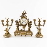 A three-piece mantle garniture clock and candelabra, gilt and patinated bronze on Carrara marble. 19
