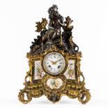 An mantle clock, gilt and patinated bronze in Louis XV style, porcelain plaques. 19th C. (L:13 x W:3