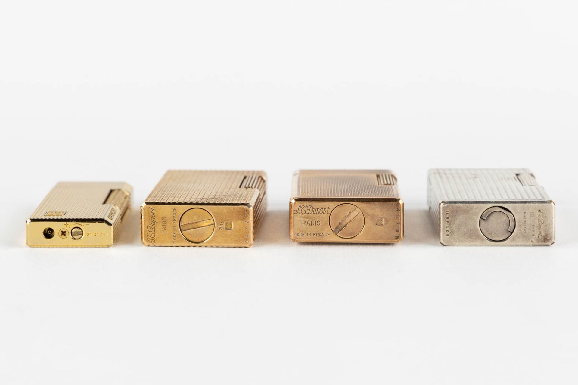 ST. Dupont, Three gold and silver plated lighters, added a Givency lighter. (L:1 x W:3,5 x H:6 cm) - Image 11 of 14