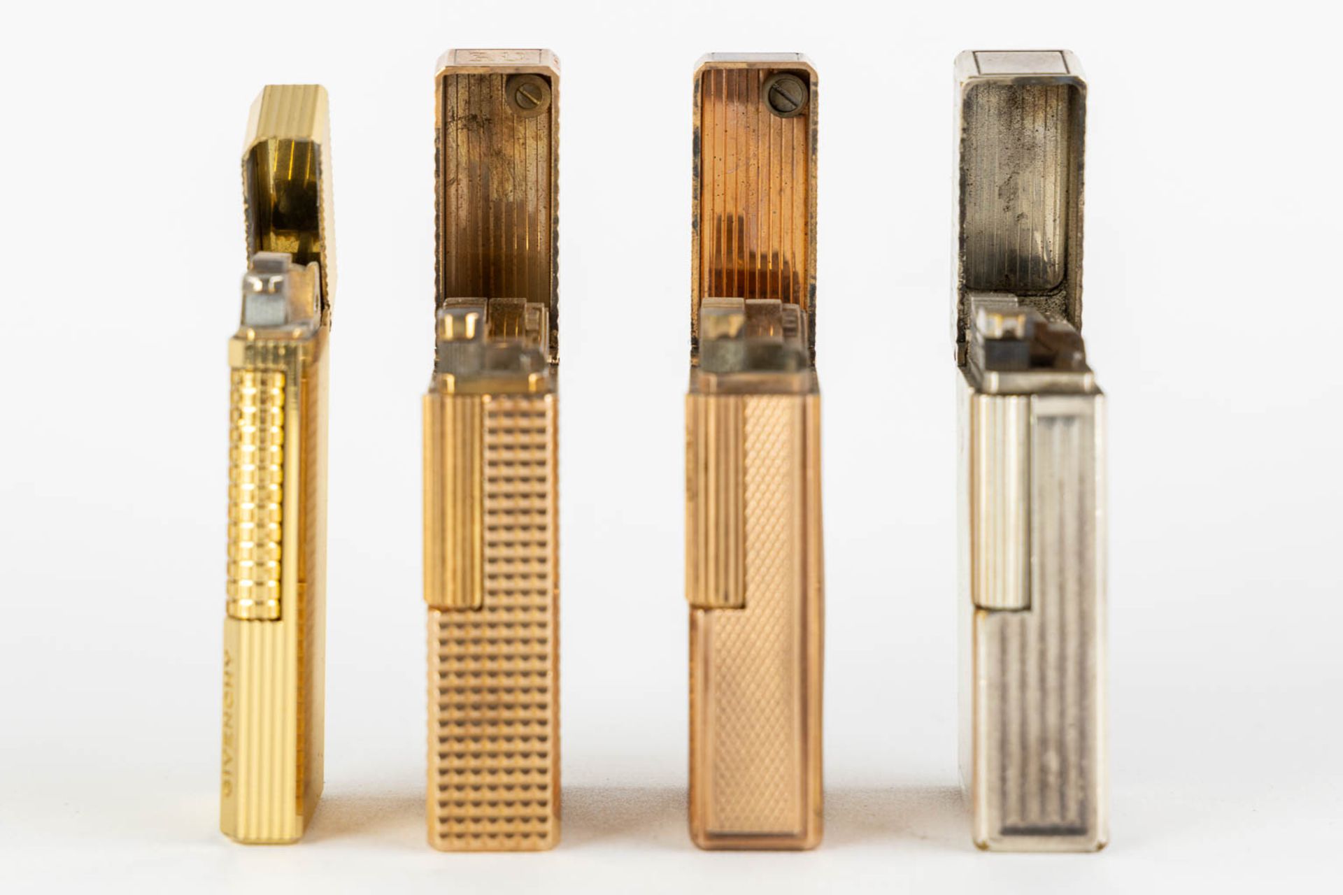 ST. Dupont, Three gold and silver plated lighters, added a Givency lighter. (L:1 x W:3,5 x H:6 cm) - Image 14 of 14