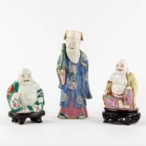 Three polychrome porcelain figurines of Buddha and Lao Tse. (L:7 x W:10 x H:24 cm)