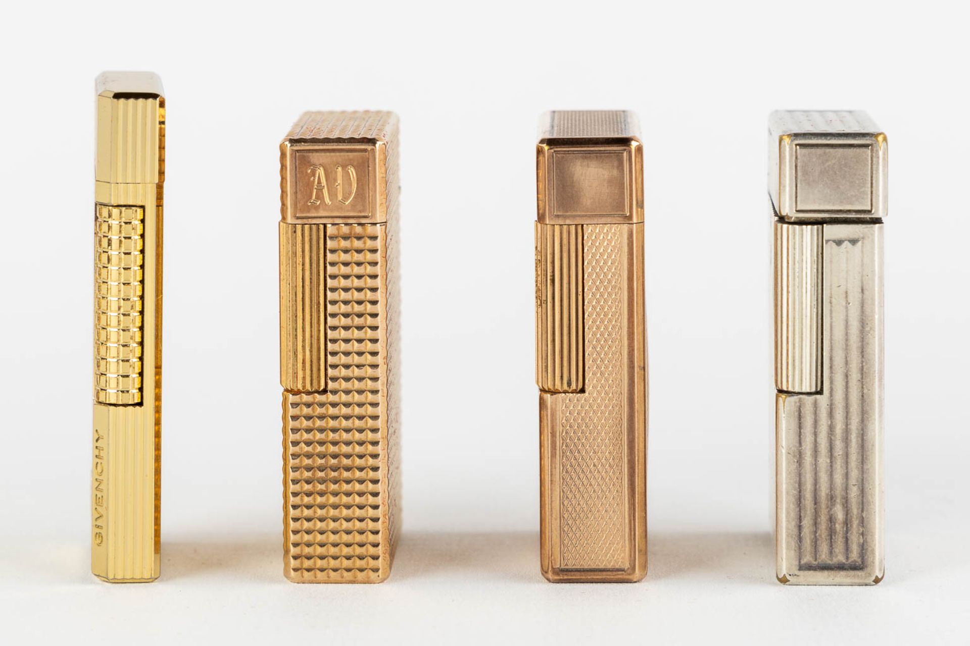 ST. Dupont, Three gold and silver plated lighters, added a Givency lighter. (L:1 x W:3,5 x H:6 cm) - Image 10 of 14