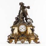 A mantle clock with a musketeer, patinated and gilt bronze on Carrara marble. 19th C. (L:17 x W:45 x