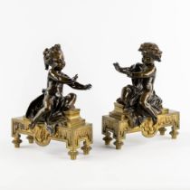 A pair of fireplace bucks, gilt and patinated bronze with boy and girl, 19th C. (L:13 x W:24 x H:31