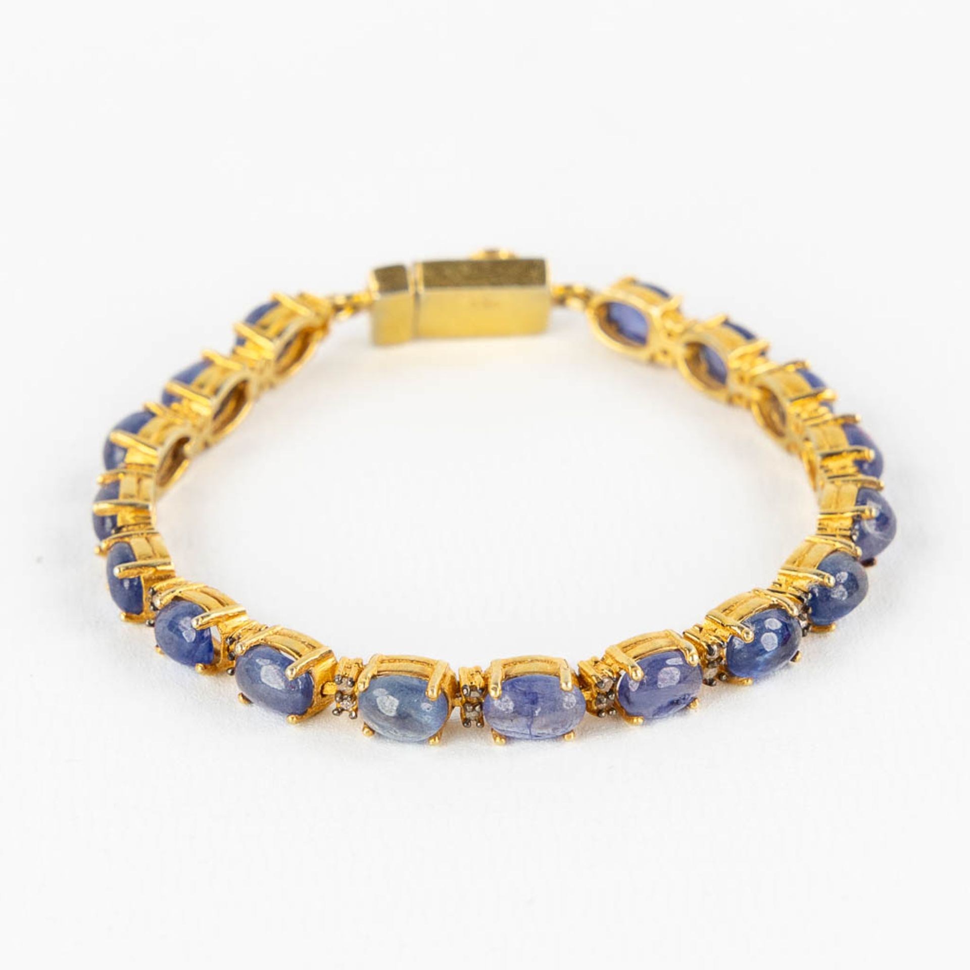 A bracelet, gilt silver with cabochon Sapphires and old cut diamonds. 23,35g.
