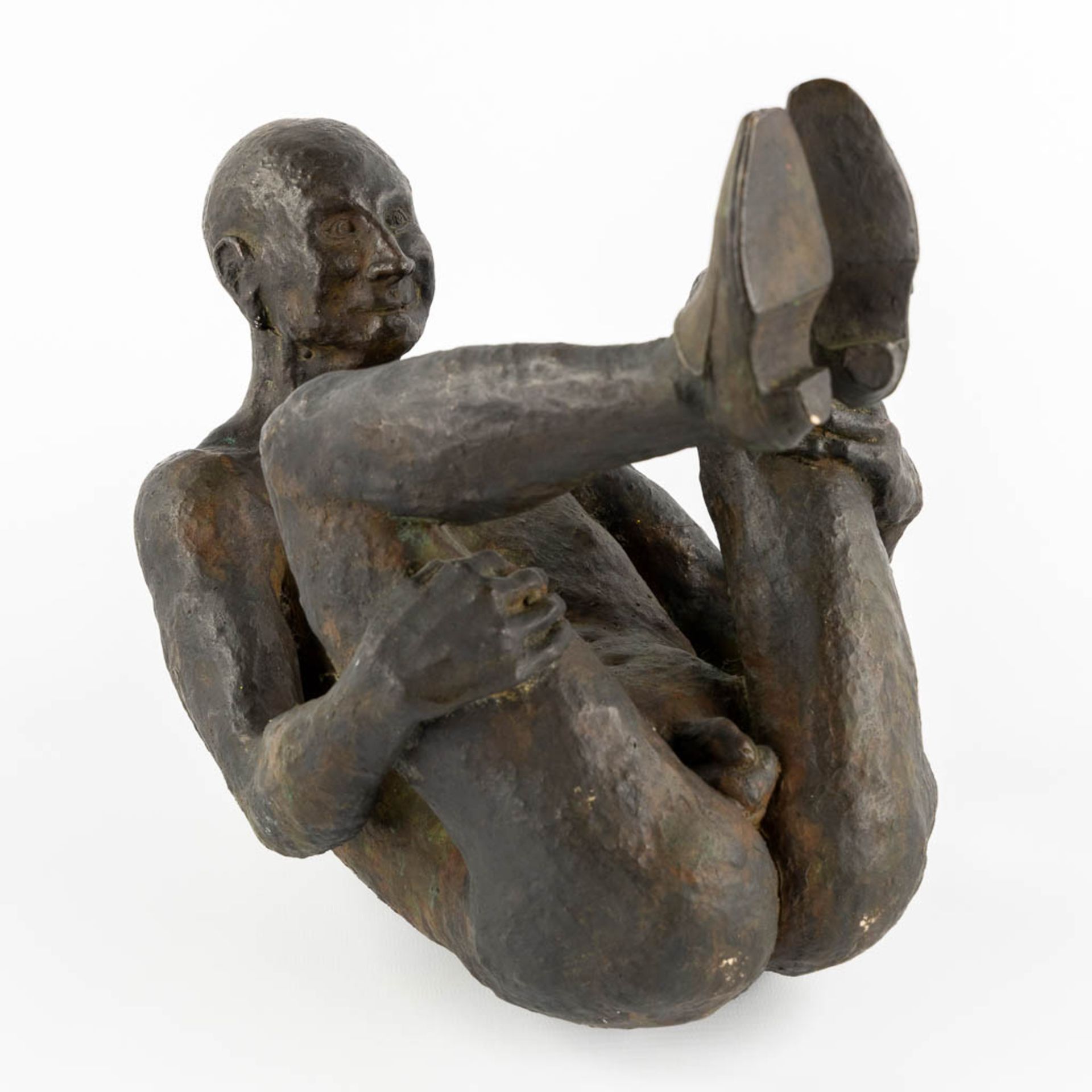 An Exposed Male figure' patinated bronze. (L:22 x W:30 x H:29 cm)