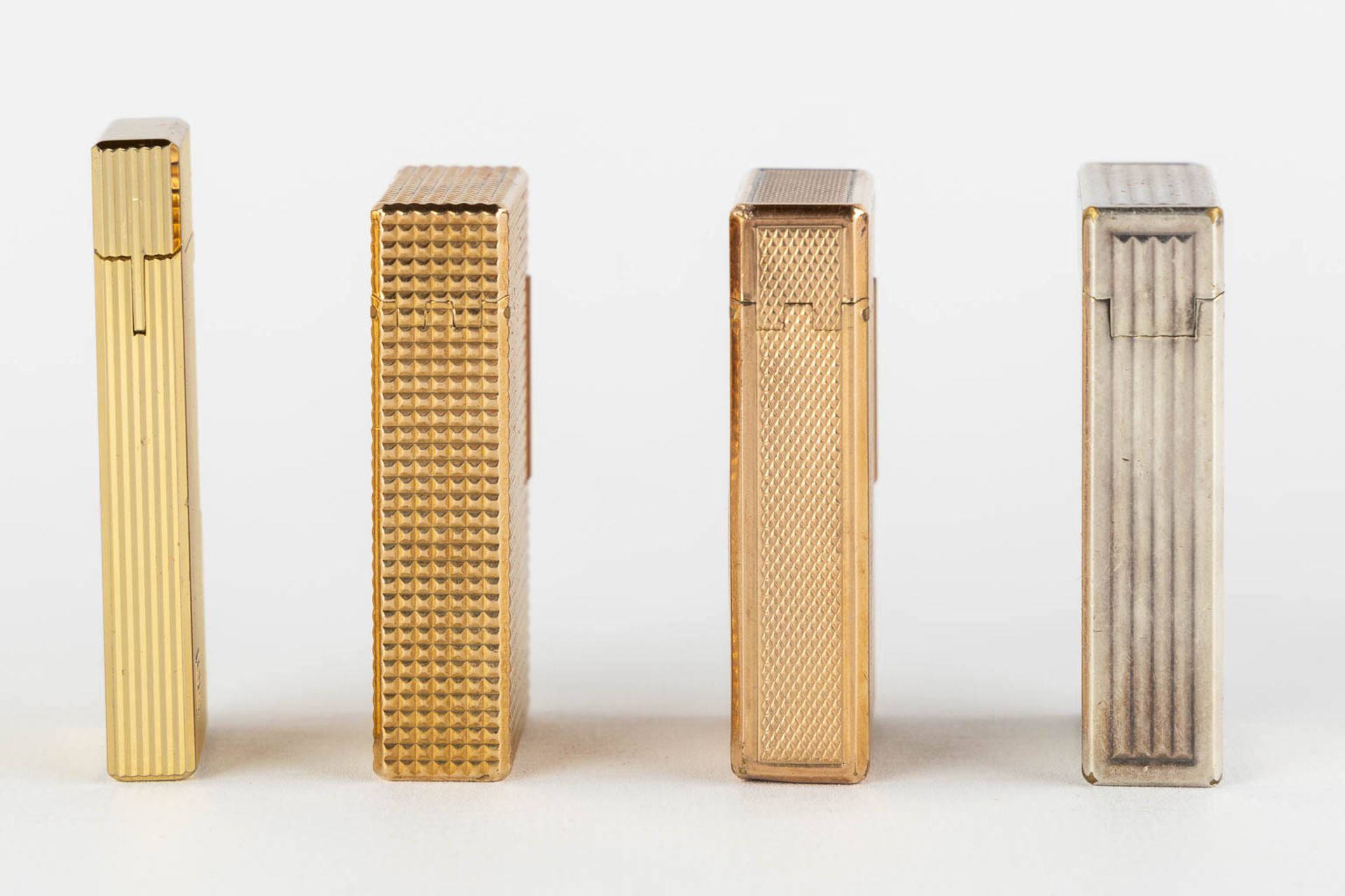 ST. Dupont, Three gold and silver plated lighters, added a Givency lighter. (L:1 x W:3,5 x H:6 cm) - Image 8 of 14