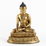 A seated buddha figurine, on a lotus flower. Gilt bronze. (L:15 x W:19 x H:22 cm)