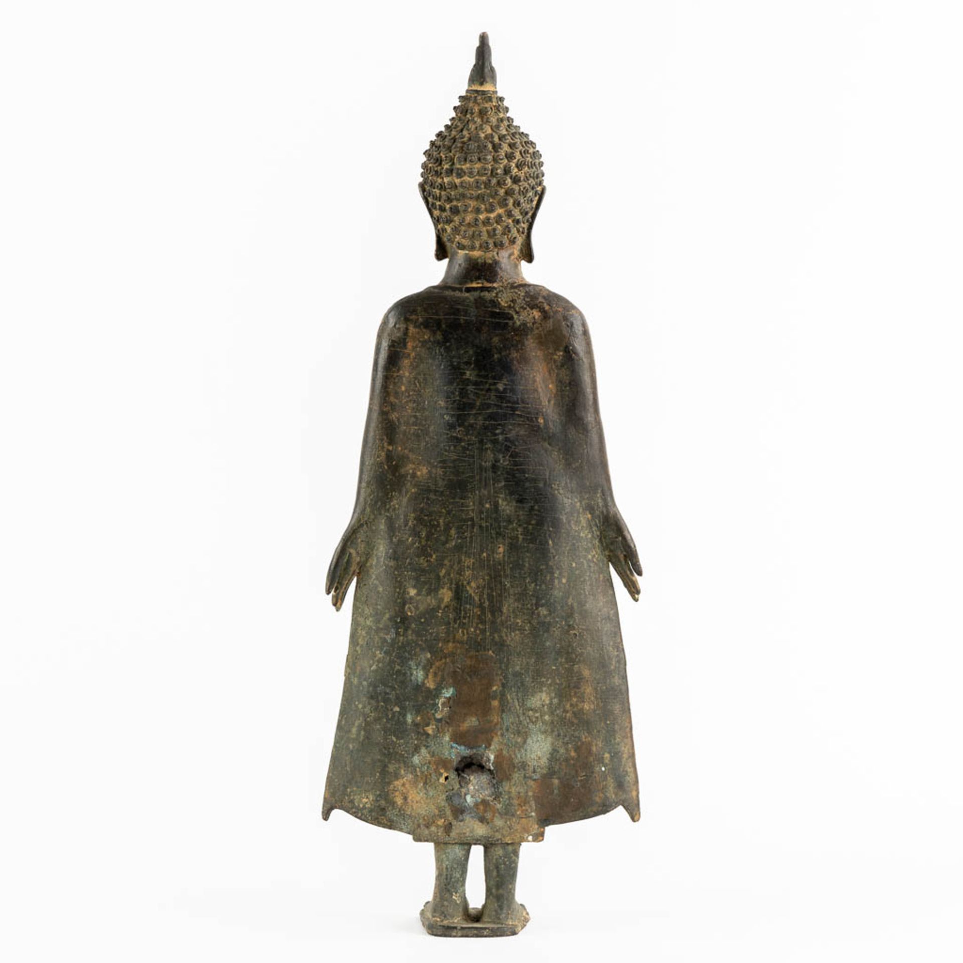 A Thai figurine of a standing Buddha, Patinated bronze. (W:16 x H:44 cm) - Image 5 of 10