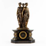 A mantle clock with patinated bronze figurines of 'The Three Graces', mounted on a black marble. (L: