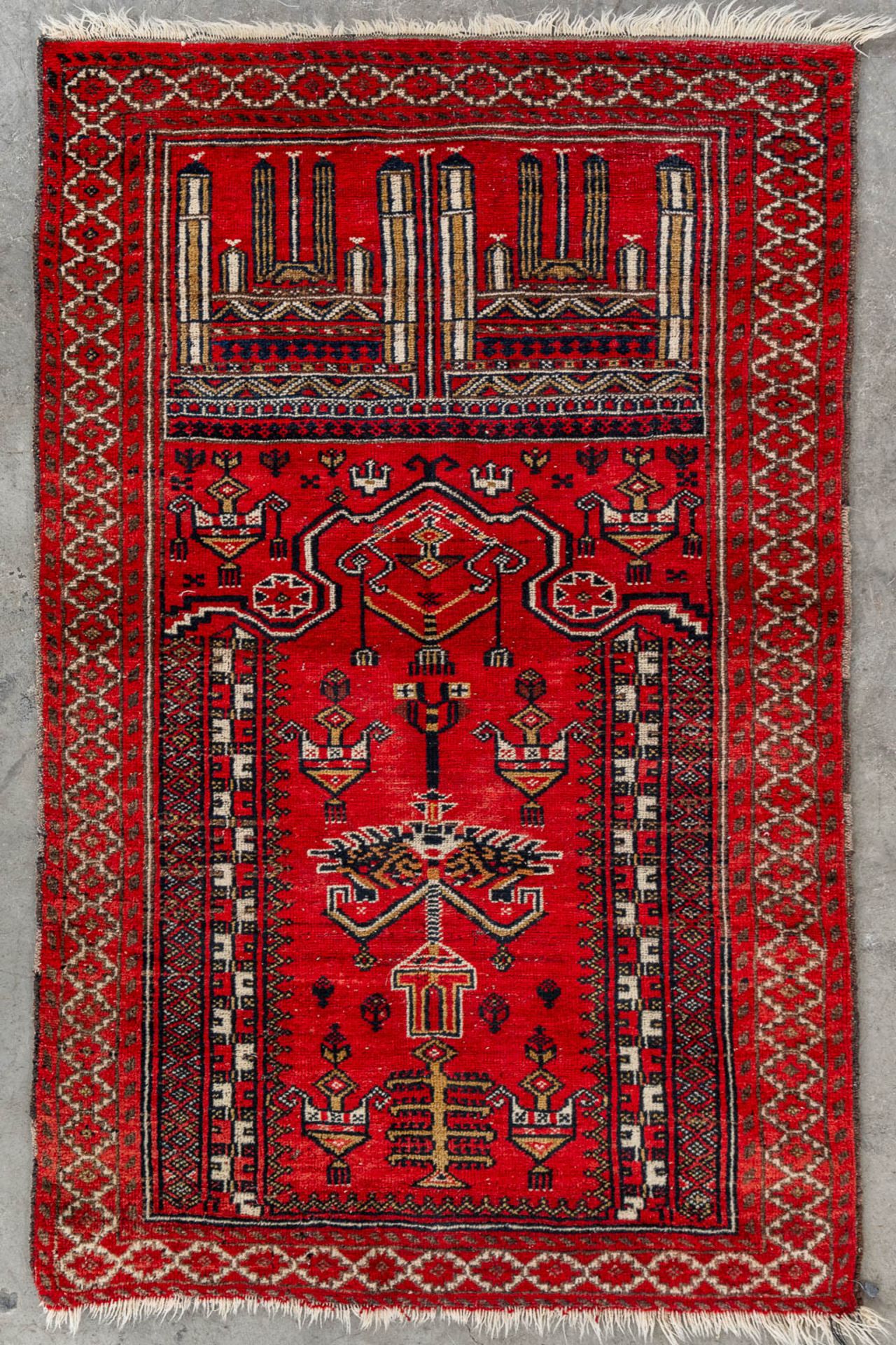 An Oriental hand-made carpet, Bellutch, Prayer rug. (L:130 x W:83 cm)