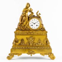 A mantle clock, gilt bronze depicting a reading lady. Louis Philippe, 19th C. (L:15 x W:38 x H:45 cm