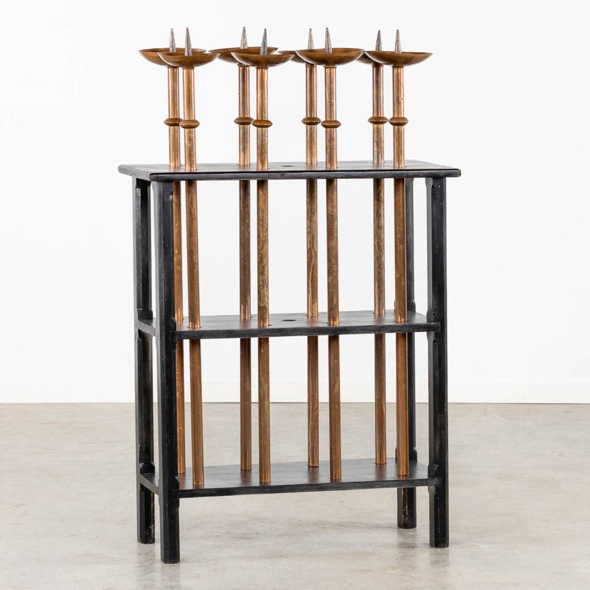 A set of 8 processional candelabra in a wood stand. (L:36 x W:75 x H:124 cm)