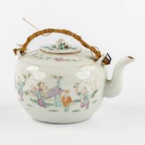 A Chinese teapot decorated with playing children and a parade. (L:12 x W:16 x H:12 cm)