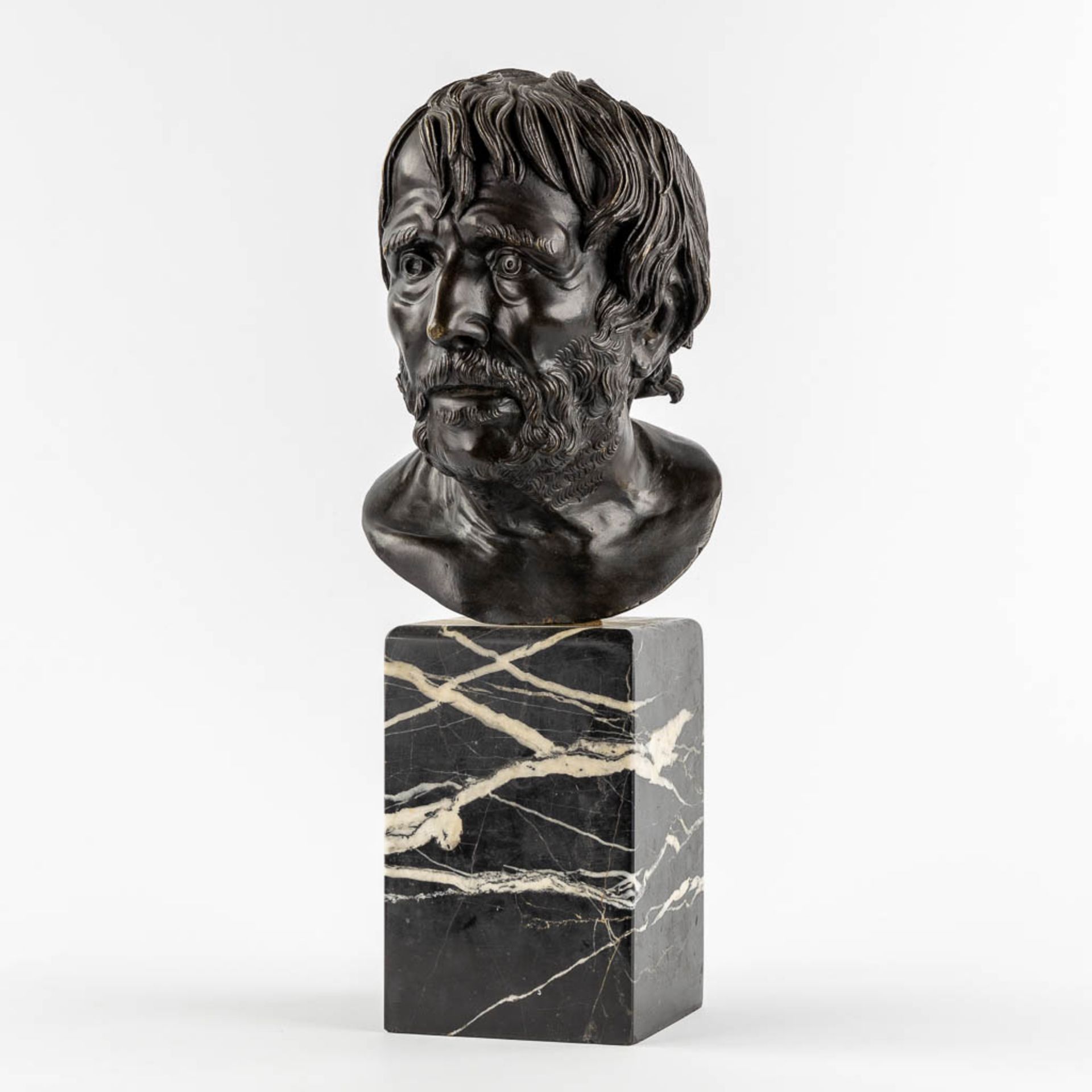 Bust of 'Pseudo-Seneca', patinated bronze mounted on a marble base. 19th C. (L:20 x W:18,5 x H:26 cm
