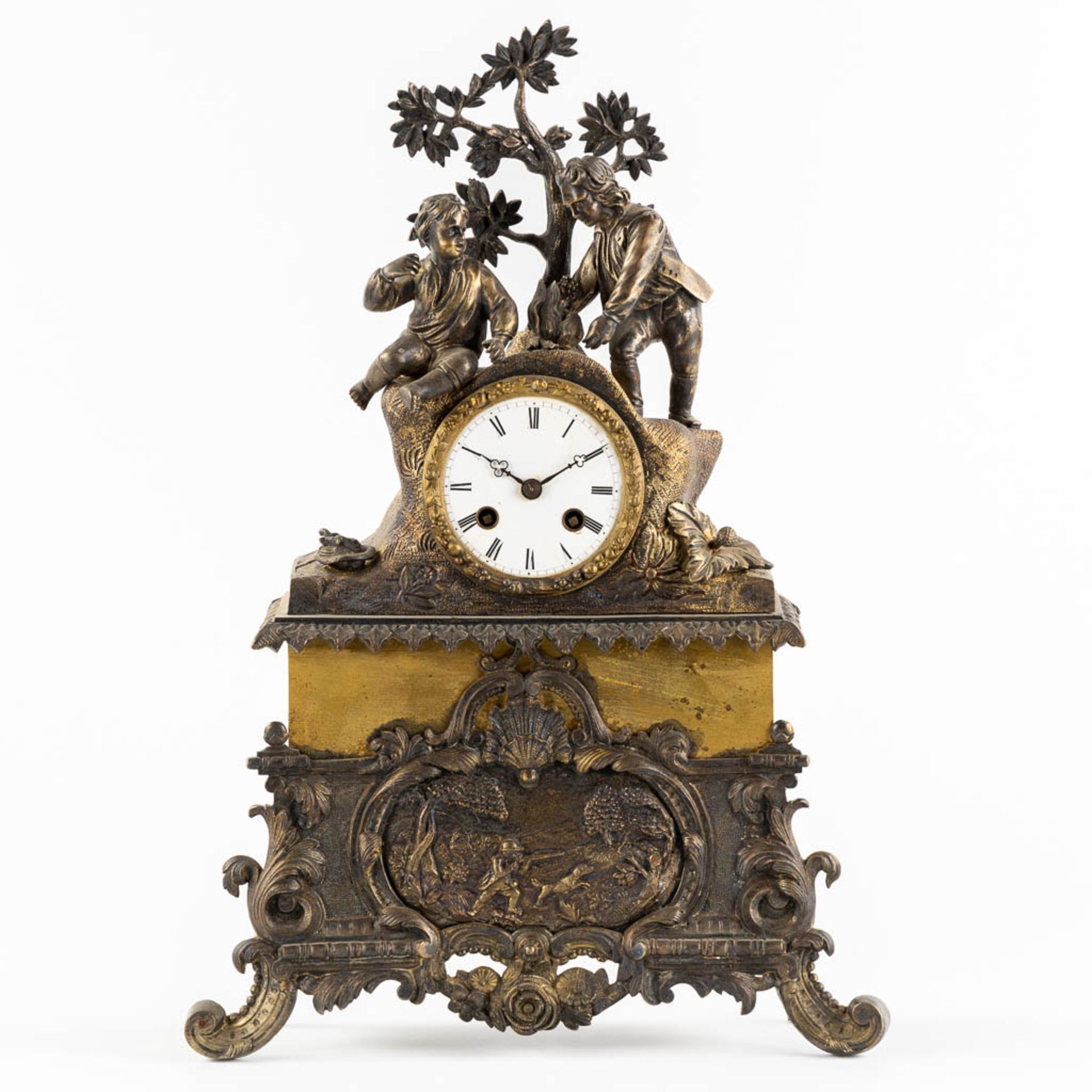 A mantle clock, patinated and gilt bronze with a hunting and camping scène. 19th C. (L:10 x W:30 x H