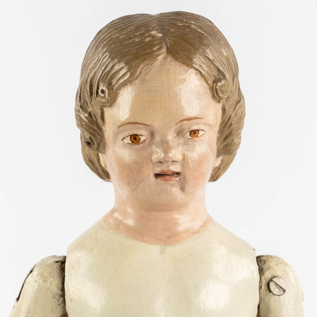 An antique patinated and wood-sculptured doll. 19th C. (L:11,5 x W:17 x H:45 cm) - Image 8 of 12