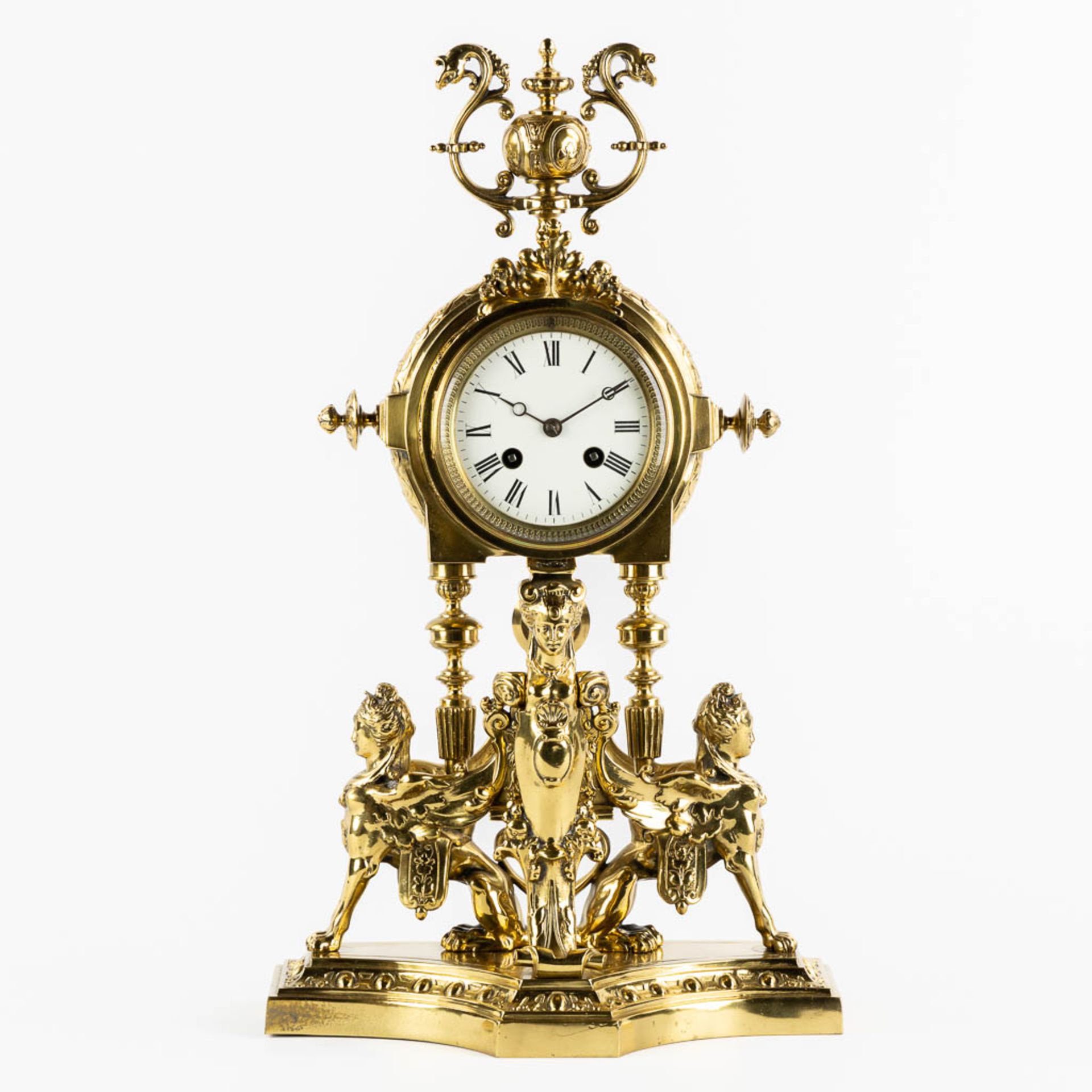 A mantle clock, polished bronze, decorated with Mythological Figures. Circa 1880. (L:15 x W:26 x H:4