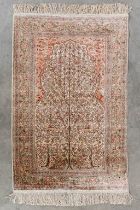An Oriental hand-made carpet with 'Tree of Life' silk. (L:82 x W:133 cm)