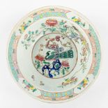 A large Chinese bowl, Famille Rose decorated with a Peacock and blossoms. 19th century. (H:12,5 x D: