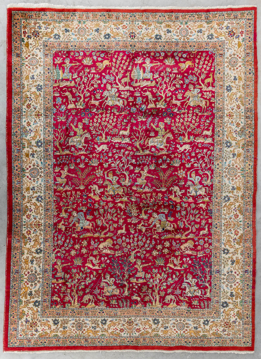 A large Oriental hand made carpet, hunting scènes, Tabriz. (L:329 x W:252 cm)