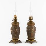 An Oriental pair of oil lamps, terracotta mounted with bronze. Circa 1900. (H:66 x D:18 cm)