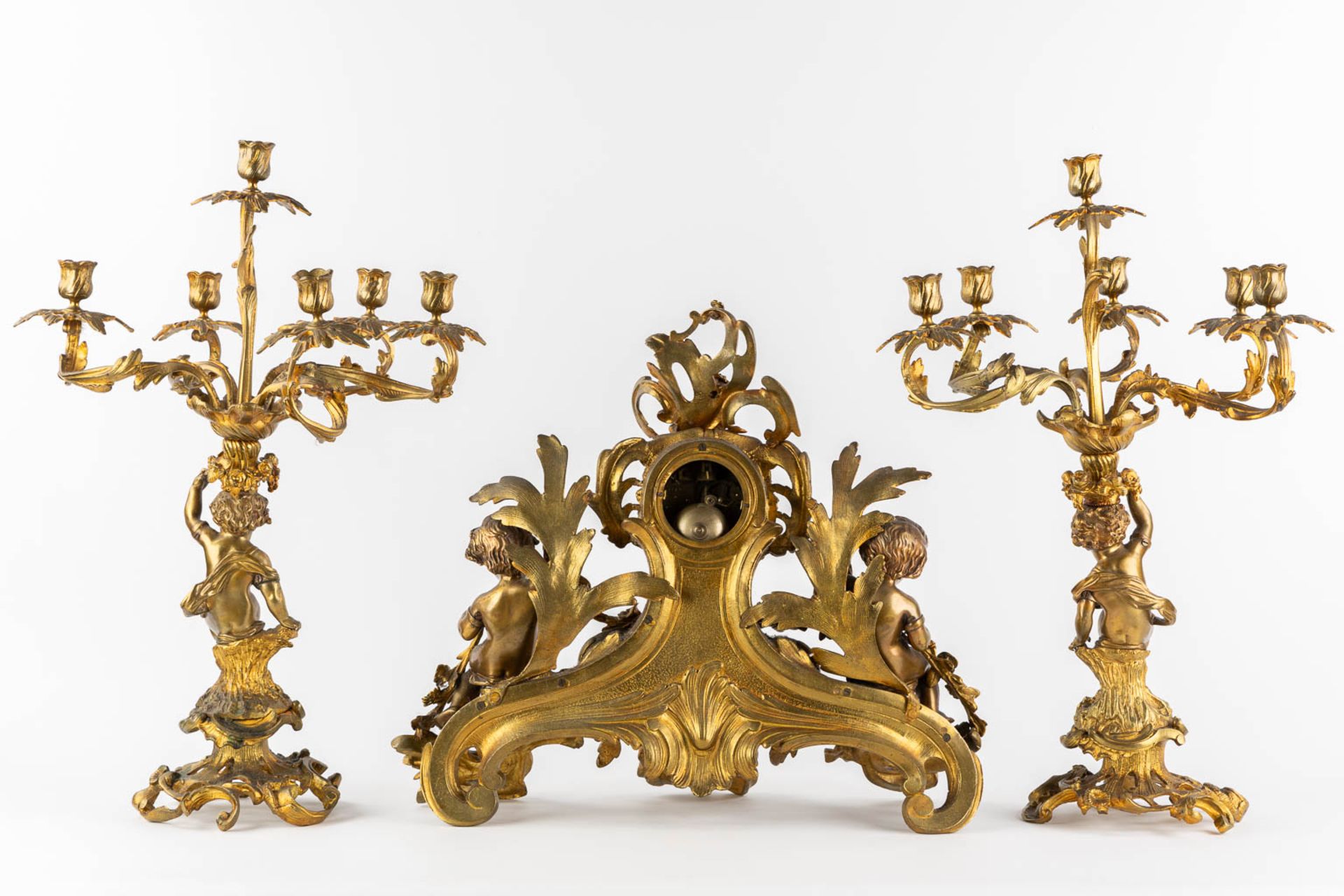 A three-piece mantle garniture clock and candelabra, gilt bronze. 19th C. (L:21 x W:55 x H:48 cm) - Image 5 of 16