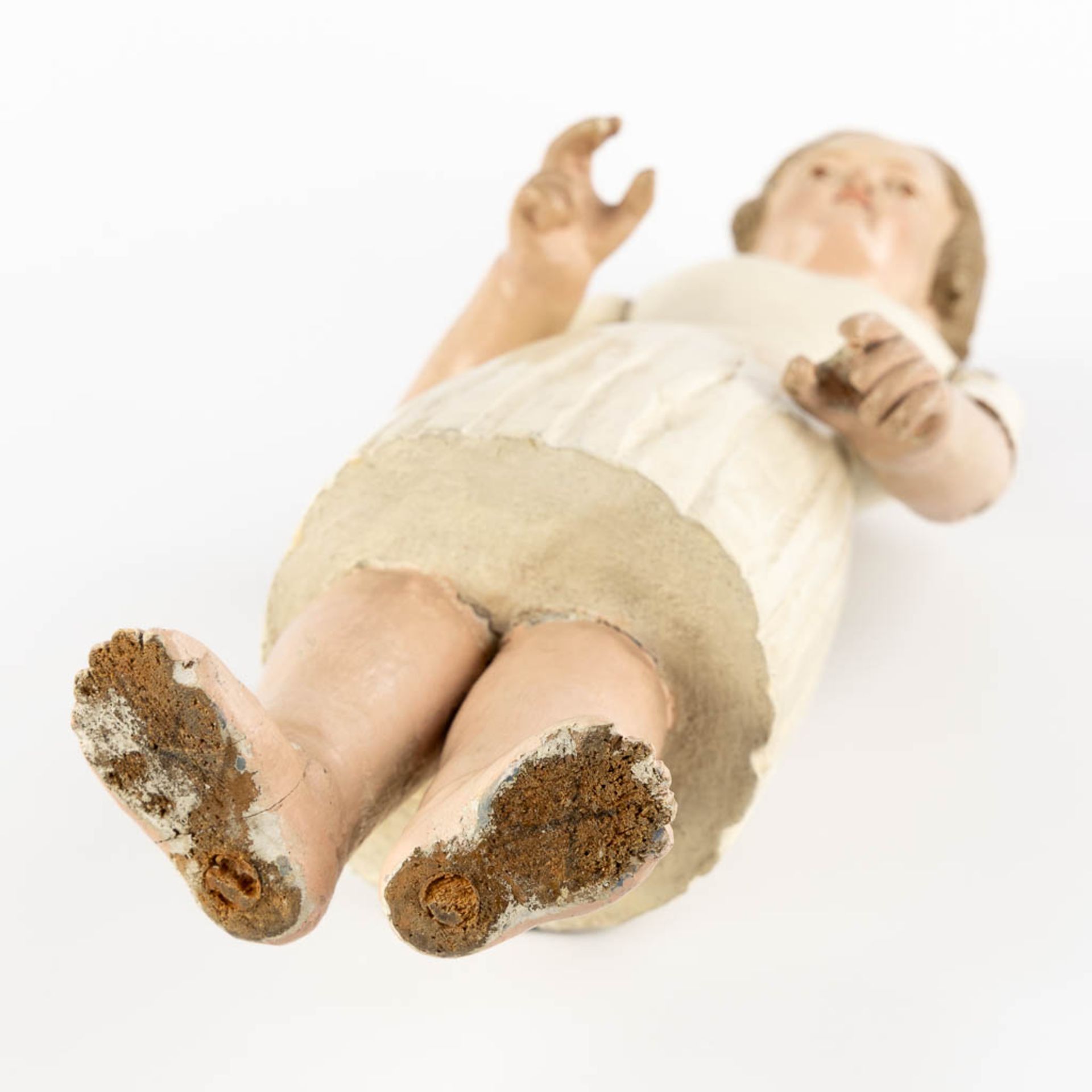 An antique patinated and wood-sculptured doll. 19th C. (L:11,5 x W:17 x H:45 cm) - Image 10 of 12