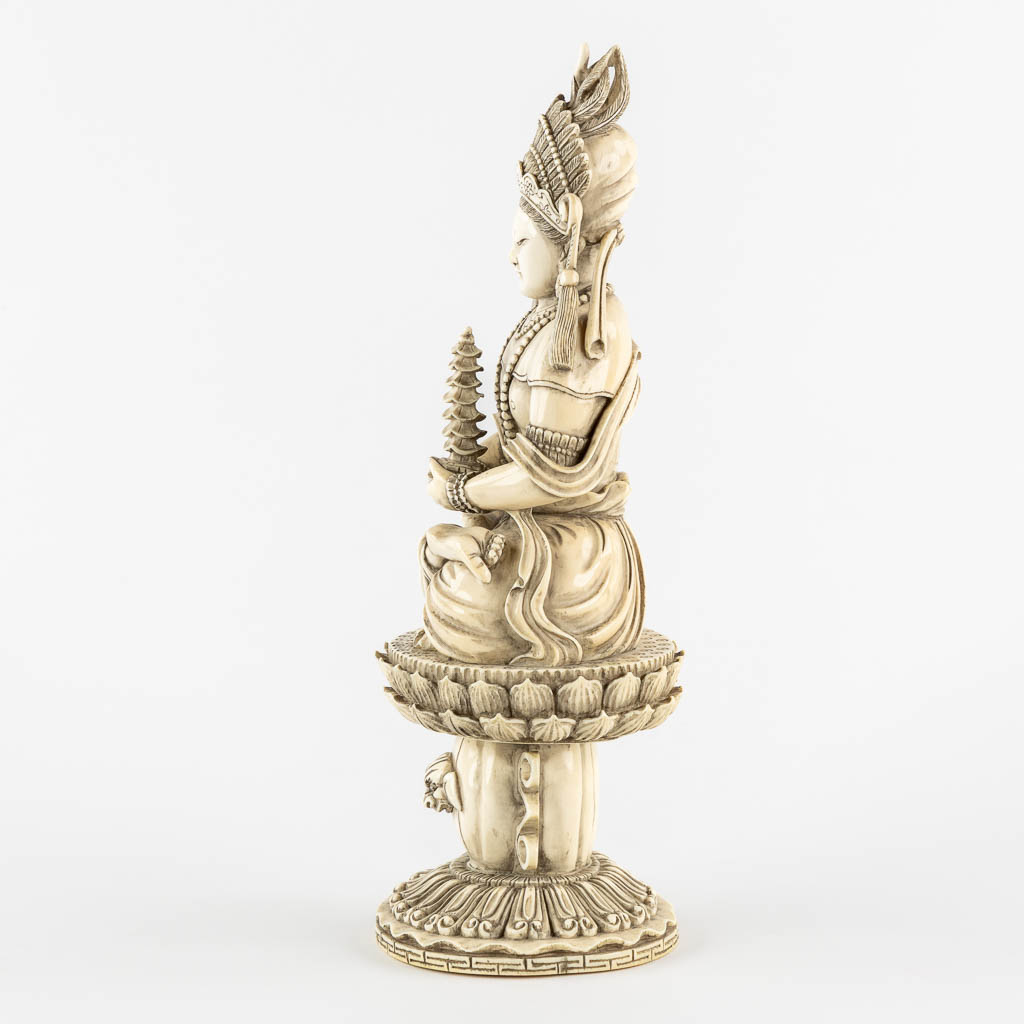 A Chinese Buddha holding a Pagoda, sculptured ivory. Circa 1900. (L:10 x W:12 x H:31 cm) - Image 6 of 11