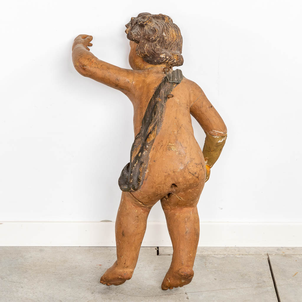 An antique figurine of a putto, sculptured and patinated wood. 18th C. (L:35 x W:34 x H:67 cm) - Image 11 of 12