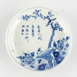 A Chinese plate, blue-white decor of fauna and flora. Kangxi mark. (H:3 x D:13,5 cm)