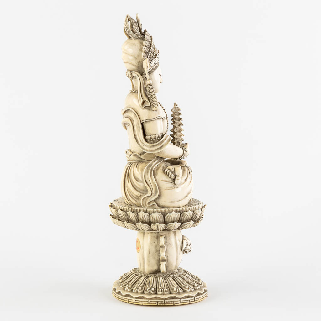 A Chinese Buddha holding a Pagoda, sculptured ivory. Circa 1900. (L:10 x W:12 x H:31 cm) - Image 4 of 11