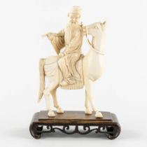 A Chinese sculptured figurine of Zhang Guolao, one of the eight immortals, ivory. (L:6 x W:12 x H:20