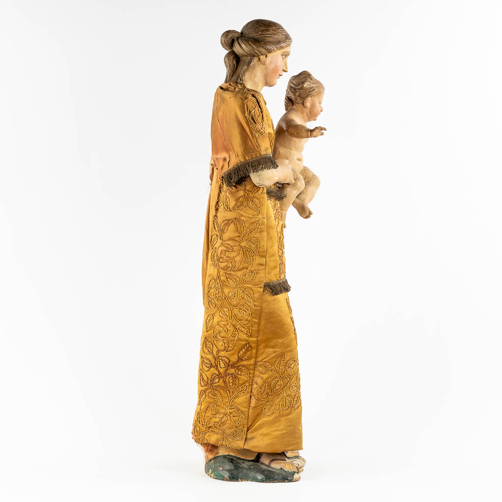 An antique sculptured figurine of a mother with child, wearing an embroidered robe. 19th C. (W:36 x - Image 4 of 15