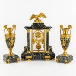 A three-piece mantle garniture clock and urns, gilt bronze on green marble, Empire style. France, 19
