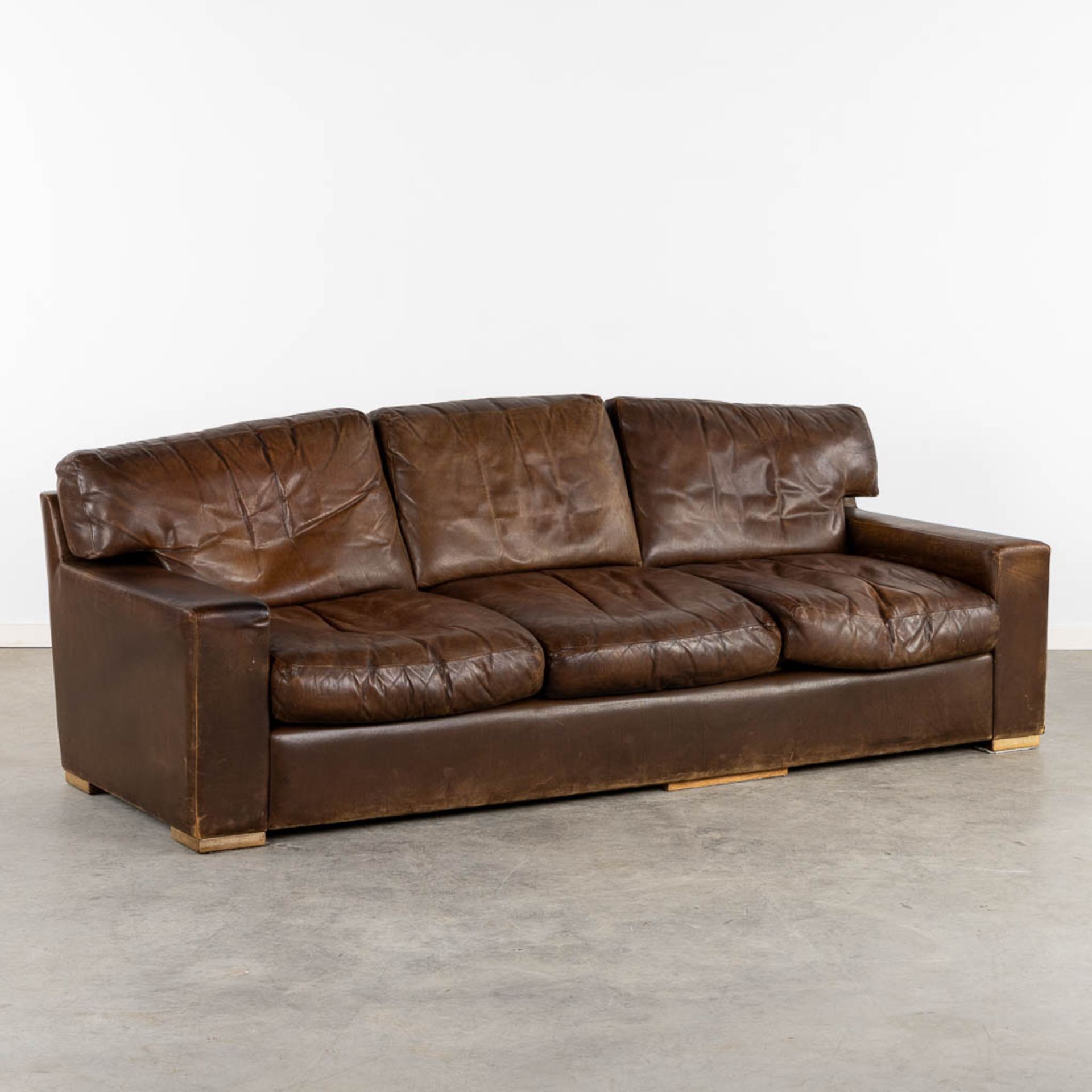 A vintage, three-person leather sofa. Circa 1970. (L:90 x W:225 x H:78 cm)