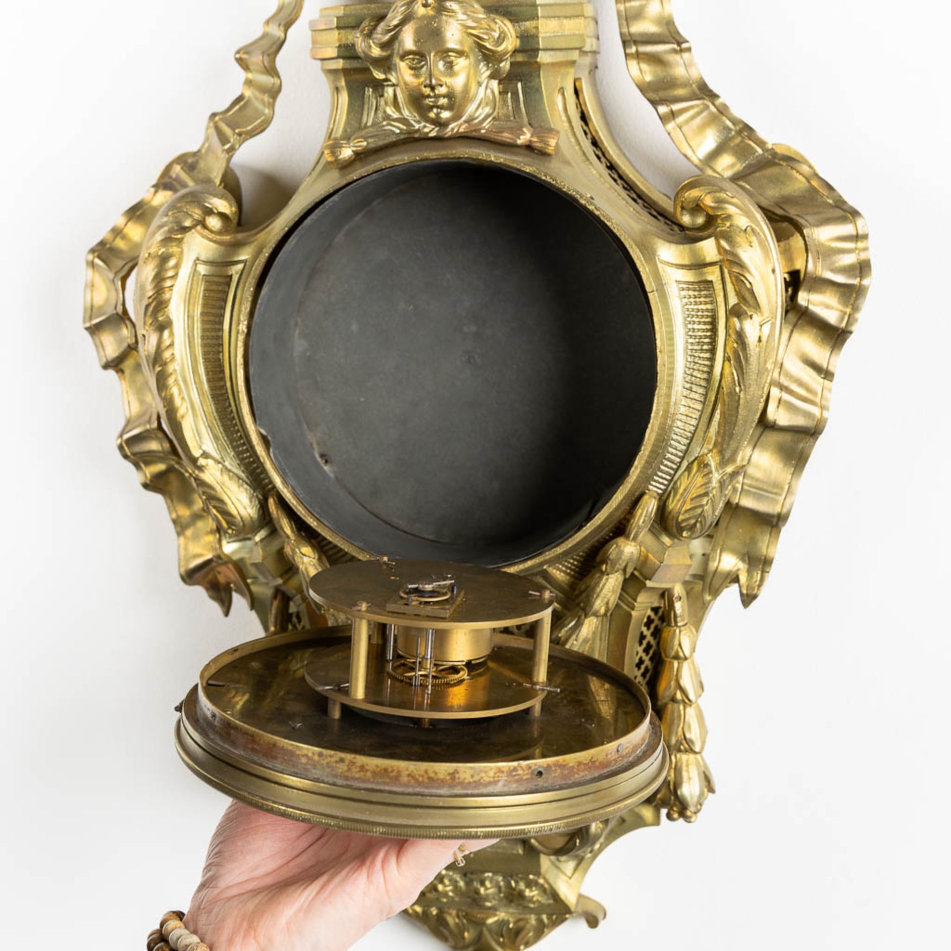 A wall-mounted bronze cartel clock, Louis XVI style. 19th C. (L:12 x W:37 x H:71 cm) - Image 6 of 7