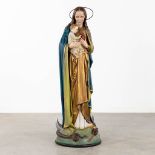 A large figurine 'Madonna standing on the cresent moon' patinated plaster. (H:130 x D:44 cm)