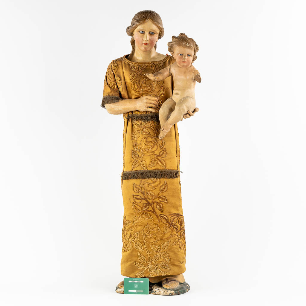 An antique sculptured figurine of a mother with child, wearing an embroidered robe. 19th C. (W:36 x - Image 2 of 15