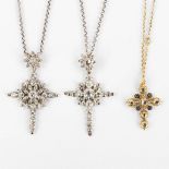 Three antique pendants in the shape of a crucifix, with old-cut diamonds. 18kt white and yelow gold.