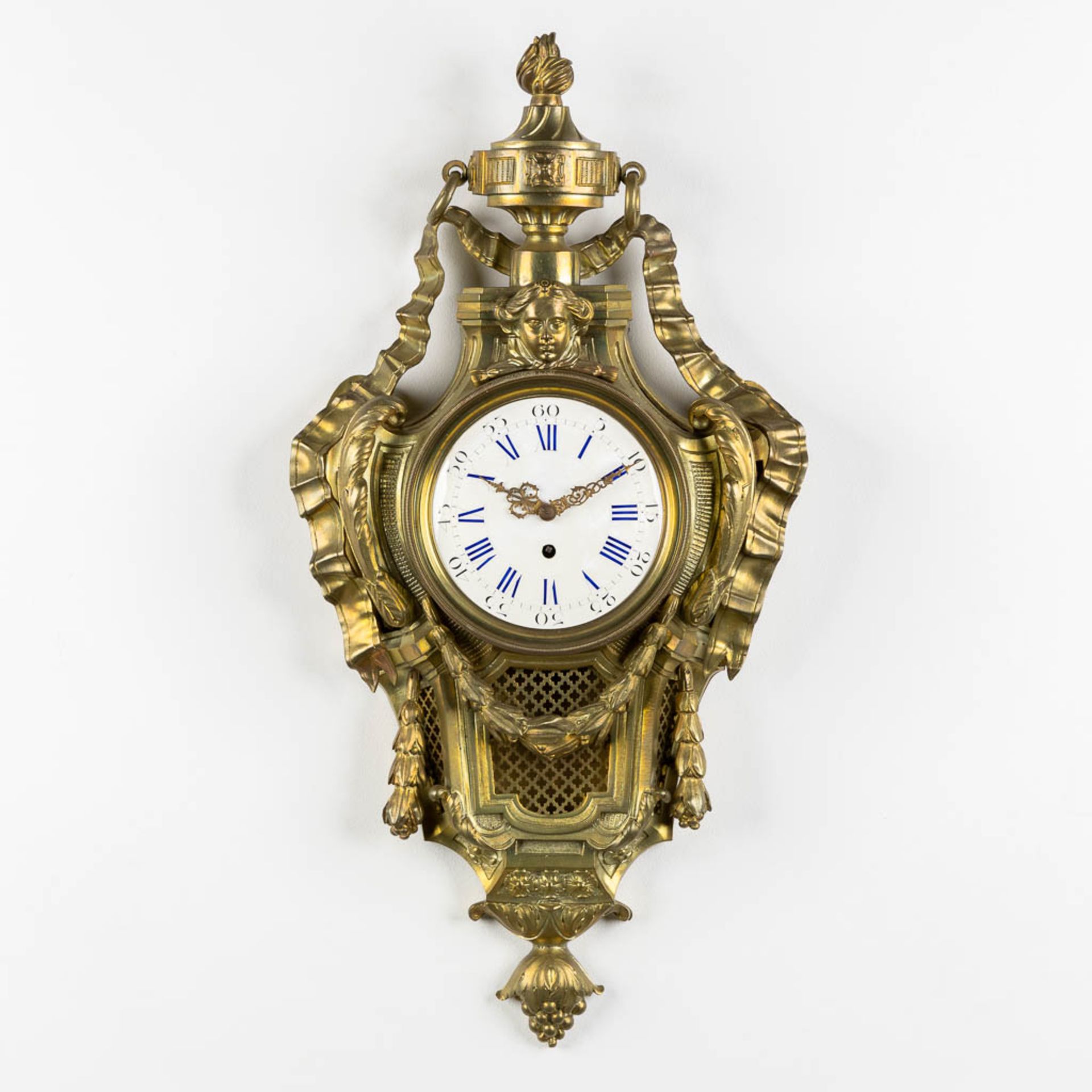 A wall-mounted bronze cartel clock, Louis XVI style. 19th C. (L:12 x W:37 x H:71 cm)