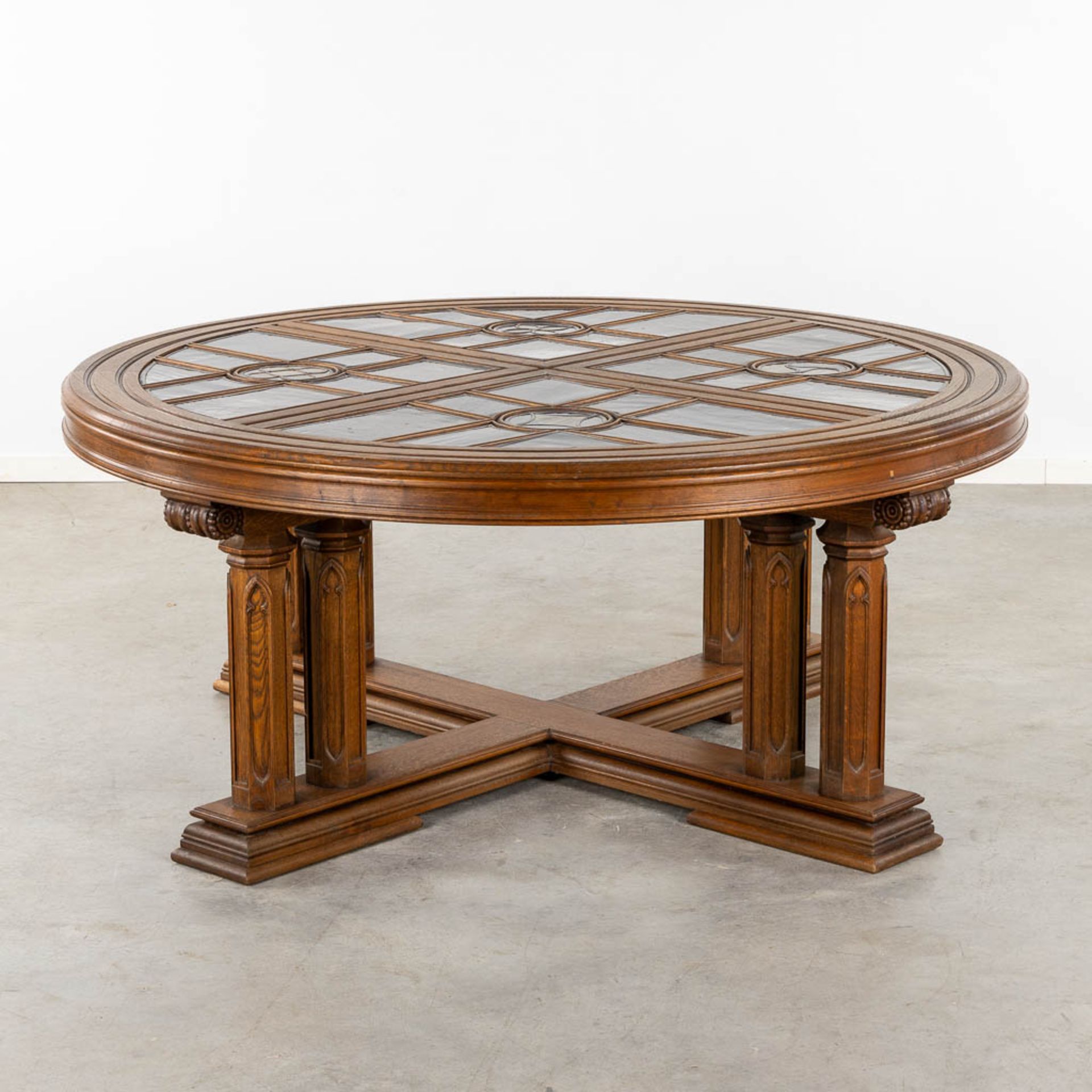 An exceptional Gothic Revival round table, inlaid with stained glass. Circa 1900. (H:78 x D:180 cm)