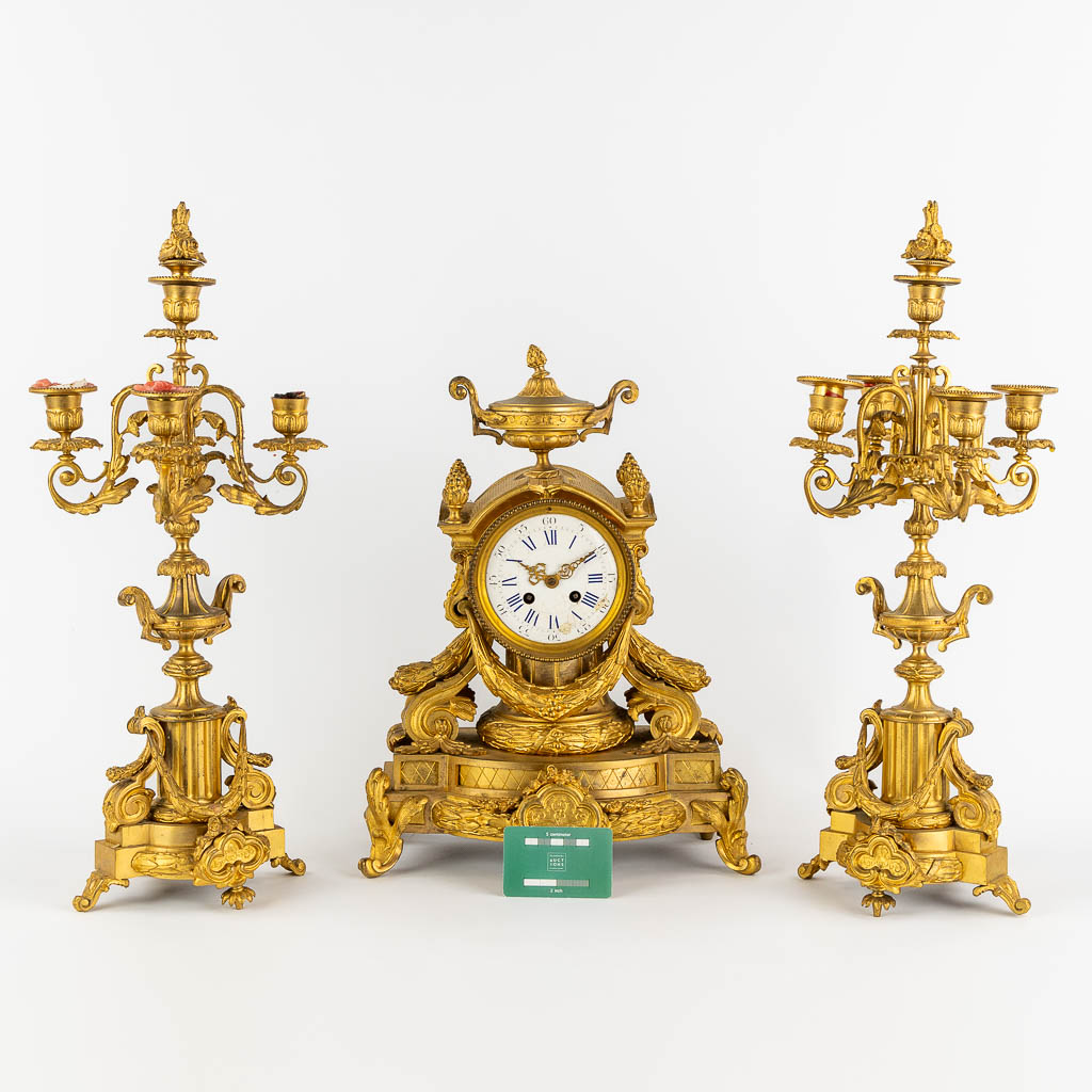 A three-piece mantle garniture clock and candelabra, gilt bronze. 19th C. (L:20 x W:32 x H:43 cm) - Image 2 of 13