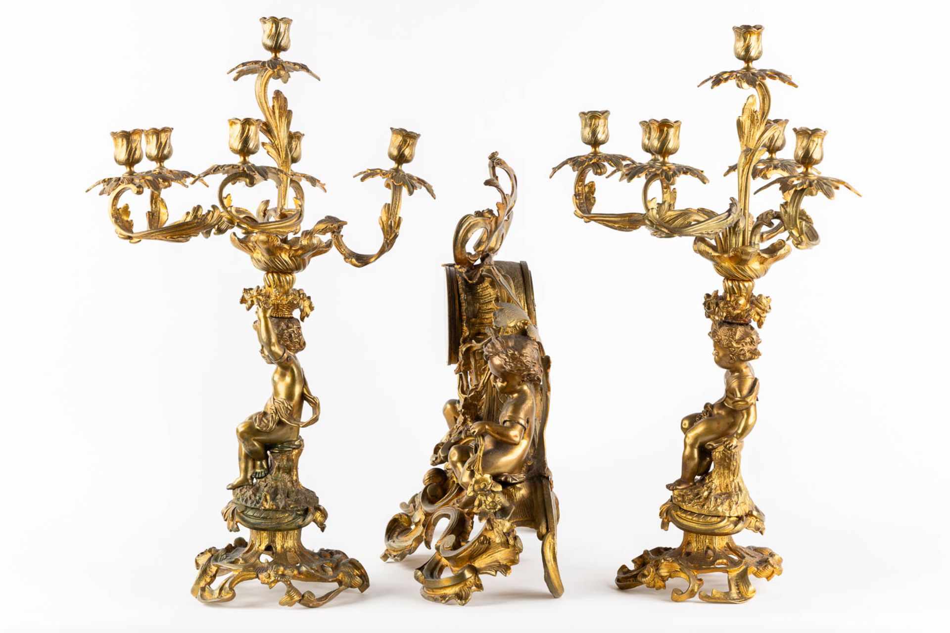 A three-piece mantle garniture clock and candelabra, gilt bronze. 19th C. (L:21 x W:55 x H:48 cm) - Image 7 of 16