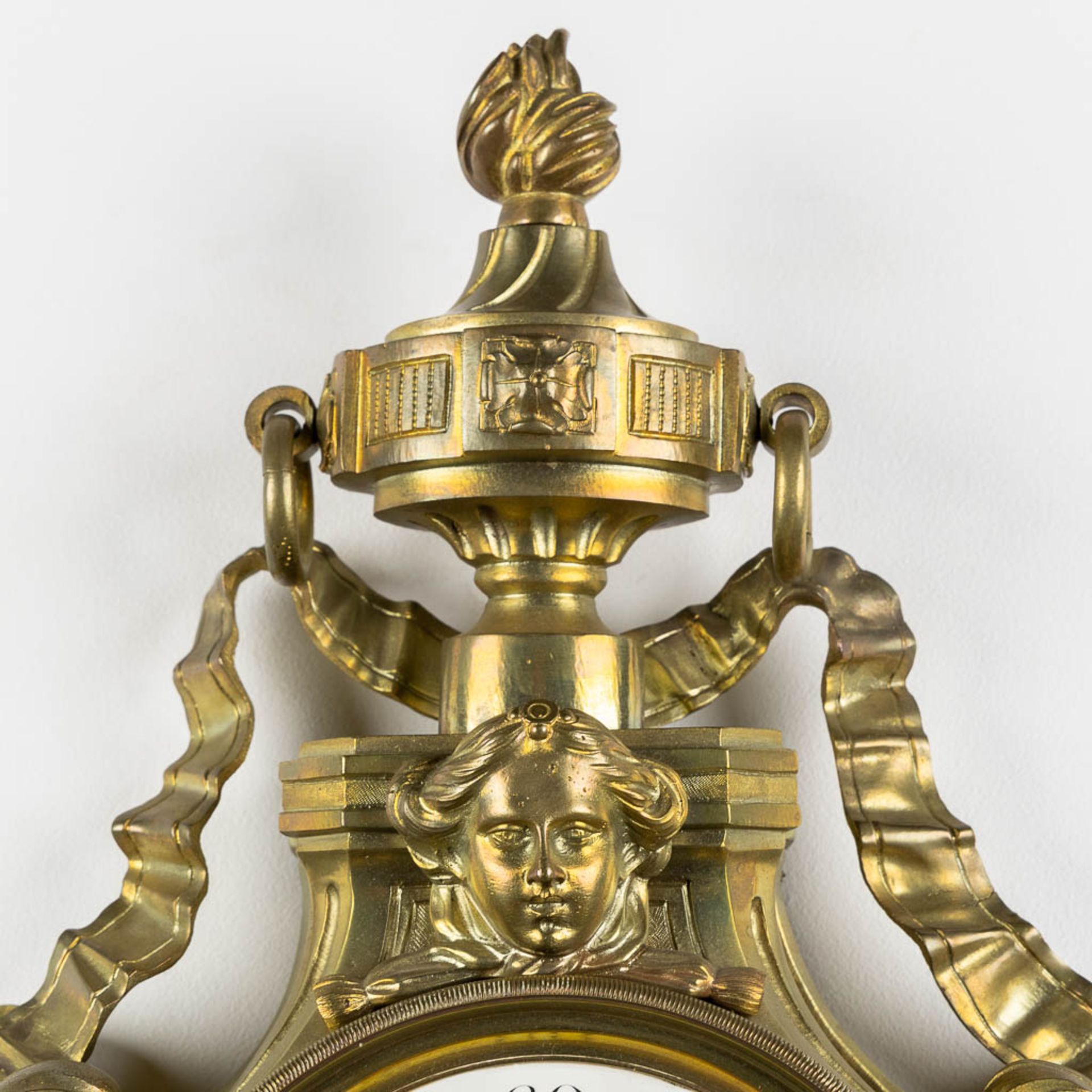 A wall-mounted bronze cartel clock, Louis XVI style. 19th C. (L:12 x W:37 x H:71 cm) - Image 3 of 7