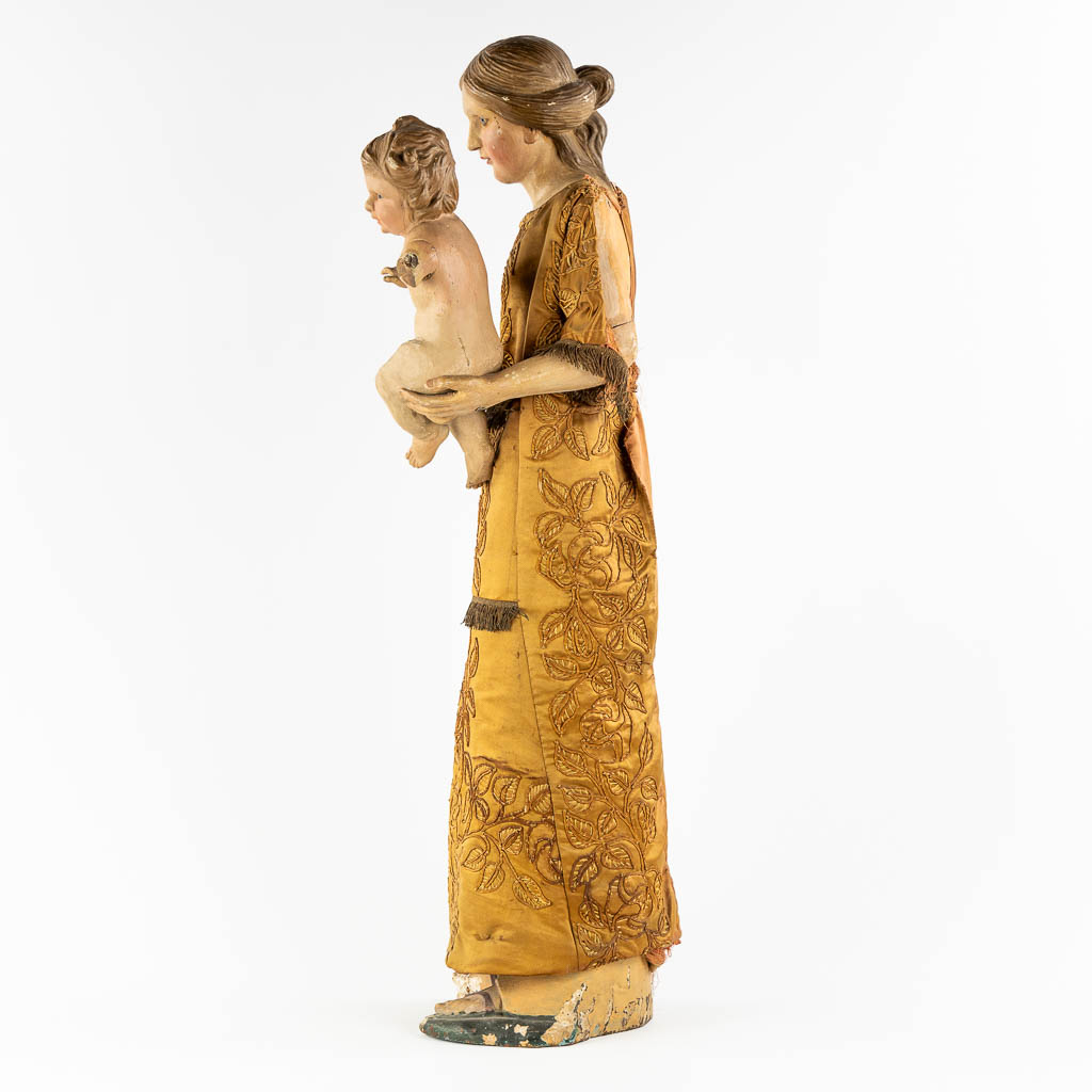 An antique sculptured figurine of a mother with child, wearing an embroidered robe. 19th C. (W:36 x - Image 6 of 15